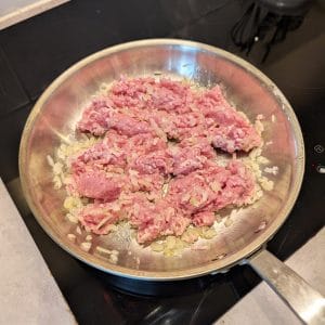 Enkel kycklingfärs enchiladas Kycklingfärs som steks i en rostfri stekpanna med lök
